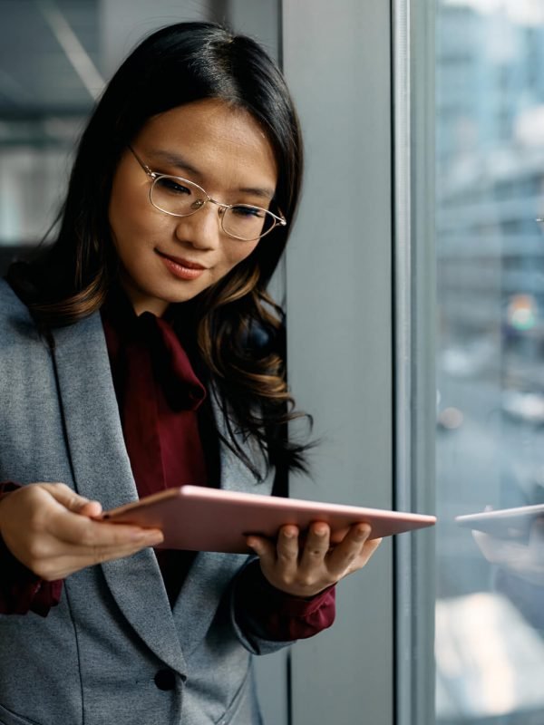 asian-female-executive-using-digital-tablet-by-the-window-.jpg