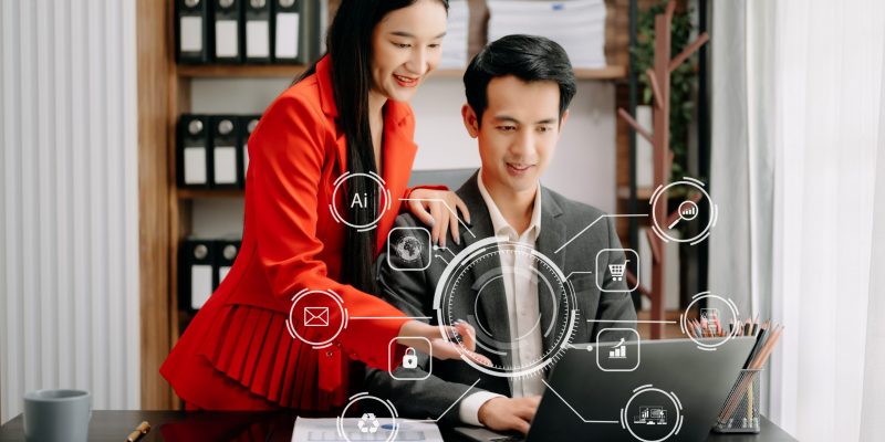 Business Asian team partnership meeting concept. Business hand using laptop, tablet and smartphone  in office. Digital marketing media mobile app in virtual icon screen in morning light